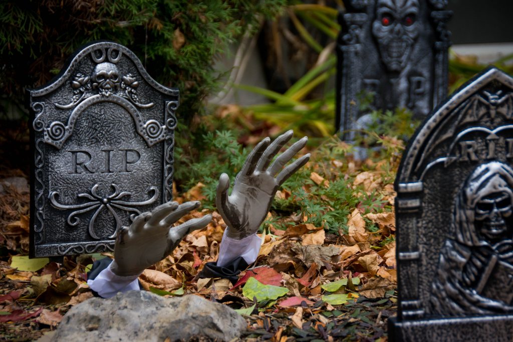 hands emerging from grave tombstone outdoor Halloween decor Montreal lifestyle blog